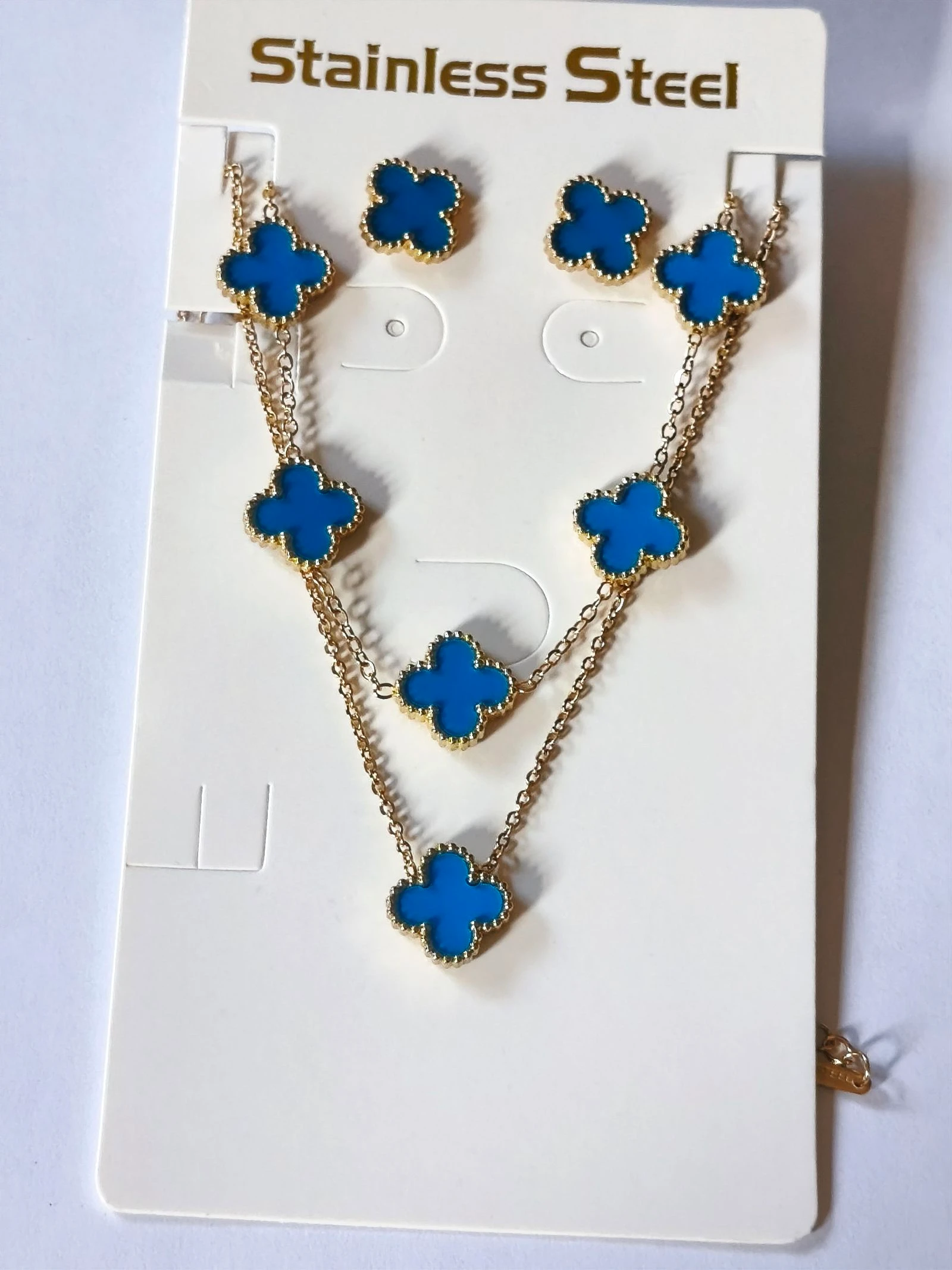 Conjunto de gargantilla pulsera y pendientes de trebol azul claro con cadena dorada